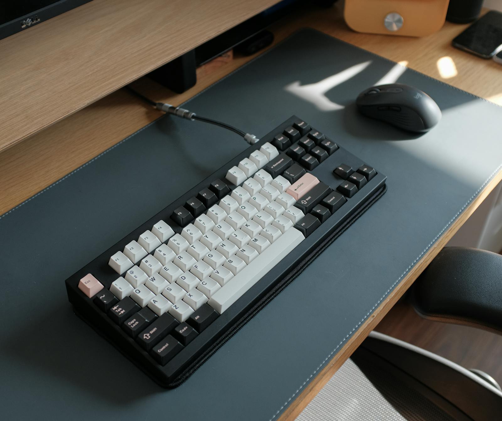 A bespoke mechanical keyboard with sculpted keycaps photographed on a warm linen surface.