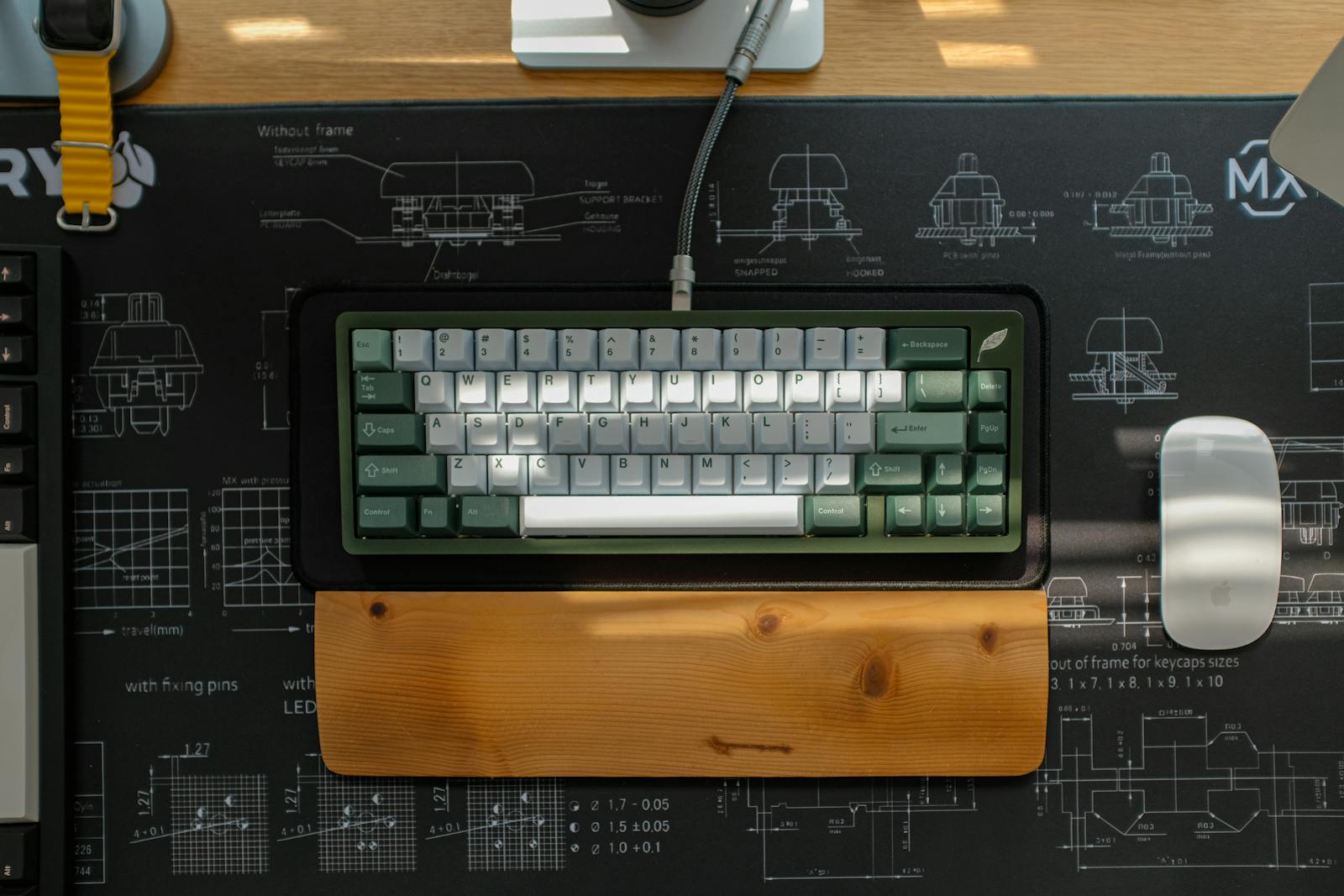 Premium keyboard staged beside a notebook.